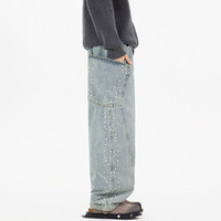 Pantalon en jean délavé et déchiré à jambe large avec broderie de perles - Style coupe ample et incurvée - Marque Couture