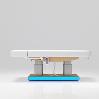 Table de massage électrique à 4 moteurs avec éclairage LED, colonne en acier inoxydable et base en bois, pour salon de tatouage et spa – Vente en gros usine