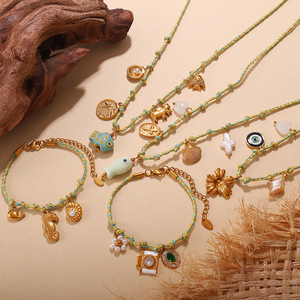 สร้อยคอรูปเปลือกหอยชุบทอง 18K สแตนเลสสตีล พร้อมจี้ปลาดาวเซรามิก ชุดกำไลข้อมือ ของขวัญเครื่องประดับสำหรับทุกเพศ - Product Image 1