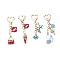 Nouveau rouge à lèvres tendance en forme de goutte d'huile, petit pendentif chat bleu, porte-clés en perles, accessoires pour sacs pour femmes