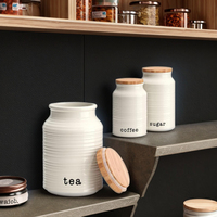 Vente en gros Bocal de rangement en céramique blanche personnalisé Boîte à café, sucre et thé avec couvercle pour les rangements domestiques et les bocaux à biscuits