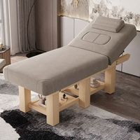Table de massage réglable en hauteur haut de gamme Foshan avec cadre en bois pour salon de beauté et SPA