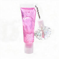 Best-seller transfrontalier : Brillant à lèvres effet miroir changeant de couleur, hydratant et repulpant, avec ornement suspendu en forme de coquille et de cœur