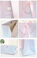Sac en papier imprimé conçu sur mesure pour l'emballage de cadeaux de boutique de mode gaufrage par stratification mate pour la poudre libre de crème pour le visage