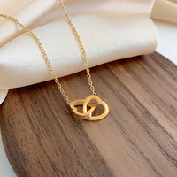 Collier en acier inoxydable doré pour femme, design ajouré cœur double, pendentif boucle, vente en gros