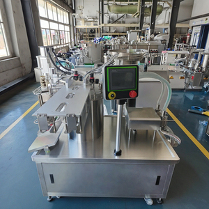 Machine de remplissage automatique à double tête et de capsulage de sachets à bec verseur pour l'industrie - pour l'emballage de lait, de miel et de produits laitiers en sachets à bec verseur - Product Image 1