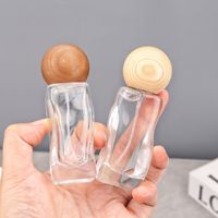 Bouteille de parfum vide en verre de 30ml en forme de vague au design unique, bouteille en verre rechargeable à brume fine pour huile essentielle cosmétique