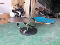 Table basse ronde moderne de luxe pour salon avec plateau mat foncé et base en acier inoxydable poli entrelacé