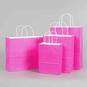 Vente en gros Sac en papier kraft Sac en papier shopping cadeau rose avec logo pour cosmétiques Sac d'emballage personnalisé