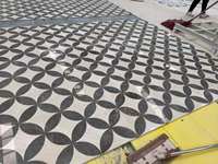 Marbre noir personnalisé avec base beige, incrustations de marbre en jet d'eau, design de marbre pour le revêtement de sol du hall d'hôtel