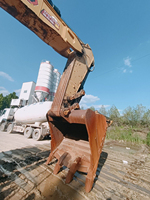 Excavatrice CAT 374 d'occasion, 74T, moteur haute puissance 359 kW, grande benne pour travaux de construction lourde