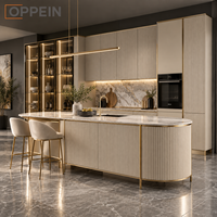 Îlot de cuisine moderne et luxueux sur mesure OPPEIN, armoire à panneaux cannelés beige avec éclairage LED pour projet de villa