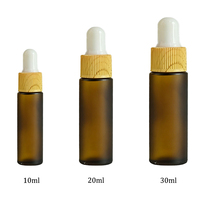 Flacon compte-gouttes en verre vide personnalisable par le fabricant avec bouchon imprimé effet bois pour l'emballage d'huile à barbe pour hommes