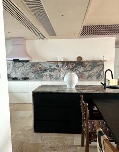 Cuisine moderne avec crédence en pierre naturelle et îlot, armoires blanches, étagères ouvertes - Product Image 4