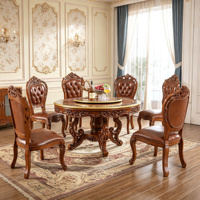 Ensemble de table à manger ronde en bois massif de style vintage européen avec plateau tournant et chaises en cuir PU sculptées à la main, mobilier de salle à manger en gros