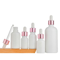 Vente en gros 5ml 10ml 15ml 20ml 30ml 50ml 100ml Essence liquide blanc laiteux Bouteilles de lotion d'huile d'essence et contenants en verre cosmétiques