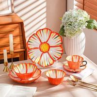 Service de table coréen en céramique à motifs floraux avec tasses et bols, orné de reliefs décoratifs, idéal pour les fêtes et les repas