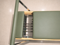 Reformer Pilates à rail fixe en bois de chêne vert sauge pour des mouvements conscientes, un bien-être inspiré de la nature et des étirements corporels