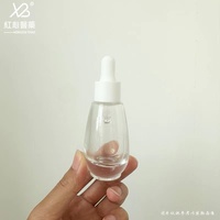 Stock du fabricant Vente en gros Bouteille transparente en verre à tête de pompe à bouche de canard avec compte-gouttes pour lotion de presse de 30ml