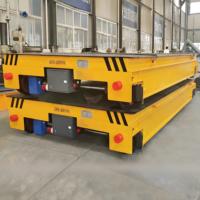 Véhicule de manutention à plateau plat électrique sans fil télécommandé de 30 tonnes, alimenté par batterie, doté d'une plateforme élévatrice et d'un système de direction sans rail