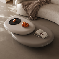 Table basse moderne en fibre de verre en forme de galet avec design rotatif pour la décoration de petits appartements