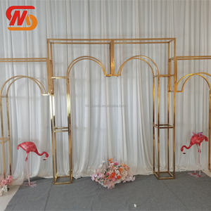 Elegante Fondo de Boda Dorado, Soporte de Acero Inoxidable en Forma de Arco con Camino de Mesa de Flores Rosadas y Sofá - Product Image 1