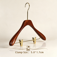 Cintre en bois massif léger avec un crochet long et une pince antidérapante en dessous pour la présentation des vêtements
