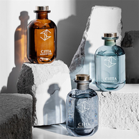 Bouteille en verre vide de luxe personnalisée de 100 ml avec surface sérigraphiée et ouverture facile pour diffuseur d'huiles essentielles