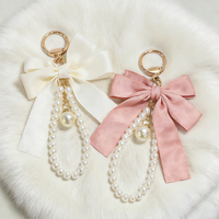 Porte-clés créatif polyvalent avec nœud papillon et petites perles, pendentif pour sac de téléphone portable pour femme