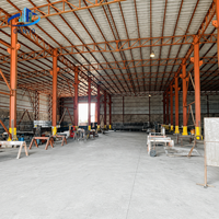Bâtiment d'usine à structure métallique avec lignes de production et zones d'équipement