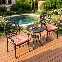 Ensemble de salle à manger d'extérieur en aluminium moulé, table ronde sculptée et chaises empilables, mobilier de jardin imperméable pour villa et cour
