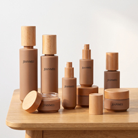 Ensemble de pots à crème pour le visage en verre kaki OEM ODM avec bouchon en bois naturel pour l'emballage cosmétique