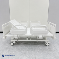Lit médical manuel 2 fonctions avec tête de lit ABS, rail rabattable en polypropylène, descente à fermeture douce, capacité 170 kg, verrouillage central, roulettes