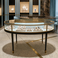 Vitrine de luxe haut de gamme pour bijoux, en verre ovale incurvé, avec cadre doré, éclairage LED, étanche, table îlot pour magasins de détail