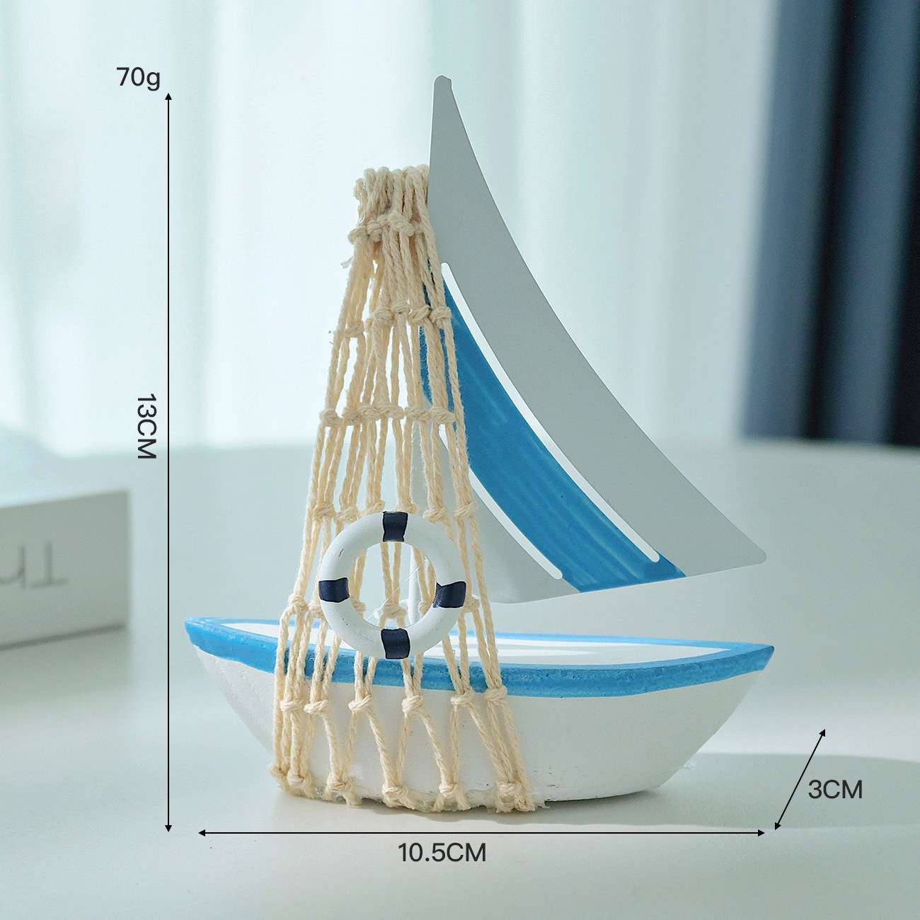Light blue tin sailboat with netting