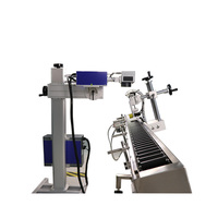Machine de marquage laser UV à positionnement automatique sur convoyeur à rouleaux pour tubes cosmétiques ronds, avec marquage de la date de production et impression de logo laser