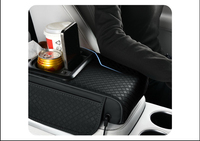 Meilleure Vente : Coussin d'accoudoir de voiture multifonctionnel de luxe avec fonction de charge, porte-gobelet, boîte de rangement et rehausseur en cuir