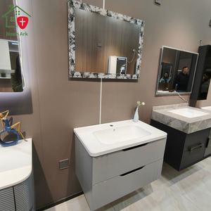 Mueble de baño gris con diseño de doble cajón, espejo con marco de encaje, encimera blanca redondeada y lavabo blanco - Product Image 4