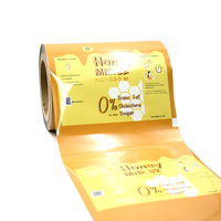 Film en rouleau laminé métallisé VMPET, impression personnalisée, film d'emballage composite en rouleau pour l'emballage de collations, de miel et de lait