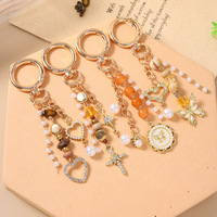 Nouveau porte-clés rond en alliage, breloque de sac en forme de croix, perles, papillon, cœur, très vendu