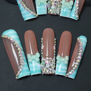 Uñas postizas de acrílico de lujo, cortas, color rosa almendra, cobertura completa, hechas a mano, con pedrería de estrellas, precio de fábrica, venta al por mayor. - Product Image 1