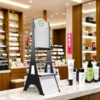 Anpassbarer Eiffelturm-Acryl-Make-up-Displayständer Umweltfreundliches Bodenregal für Parfüm-Kosmetik-Einzelhandelsgeschäft-Promotion