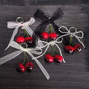 Llavero con diseño de fruta y lazo rojo cereza, con estilo adorable y dulce, para niñas - Product Image 1