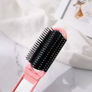 Marque privée vente en gros de mini brosse à cheveux portable en plastique pliante démêlante avec miroir pour le voyage - Product Image 4