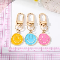 Porte-clés mignon en alliage de zinc jaune bleu noir émaillé avec visage souriant pour femmes