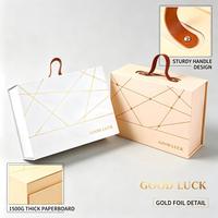 Boîte cadeau magnétique pliable de luxe avec logo personnalisé, boîte cadeau en papier rigide avec poignée en cuir pour l'emballage de cadeaux