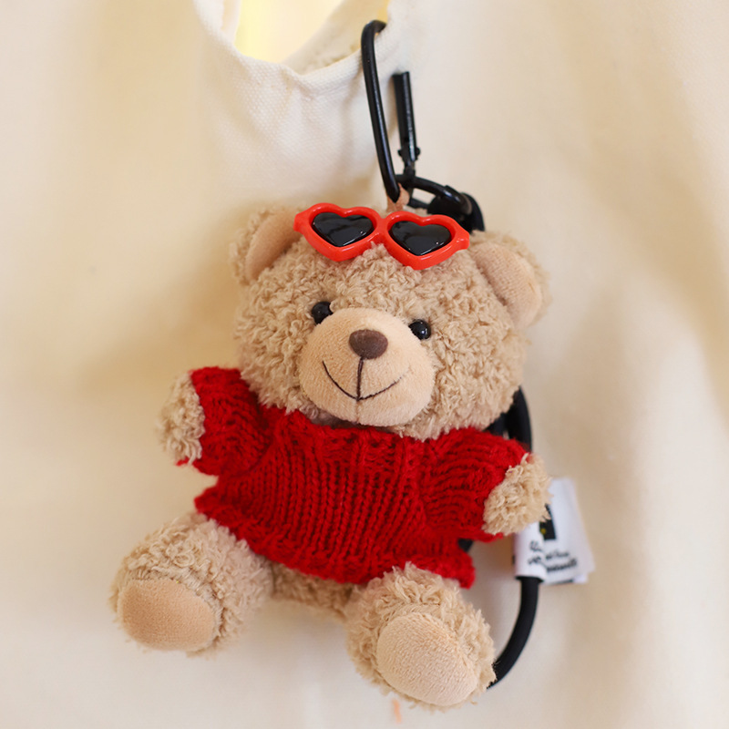 Red sweater light brown bear hand rope