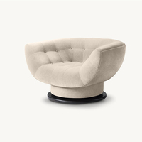Fauteuil pivotant de luxe en velours crème capitonné avec base foncée pour salon, hôtel, lecture ou comme fauteuil d'appoint