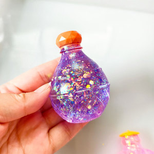 Juguete Antiestrés de TPR con Forma de Botella de Perfume, con Polvo Dorado, para Regalo - Product Image 1