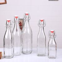 Bouteilles en verre transparent/ambre/bleu de 12 oz, 16 oz, 34 oz avec bouchon à bascule, couvercle de fermeture à verrouillage pour le lait, les boissons, les sauces, les liqueurs/les alcools